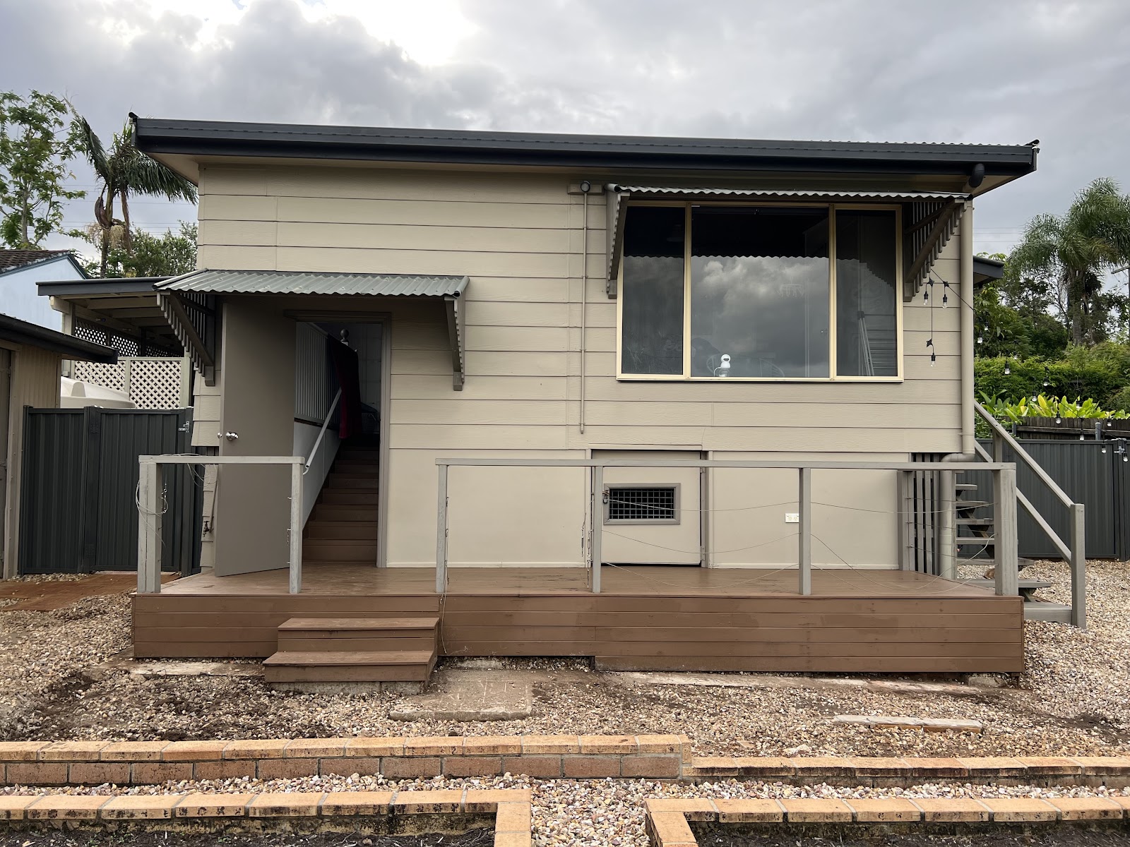 The same deck finished, with steps, handrail and new garden beds