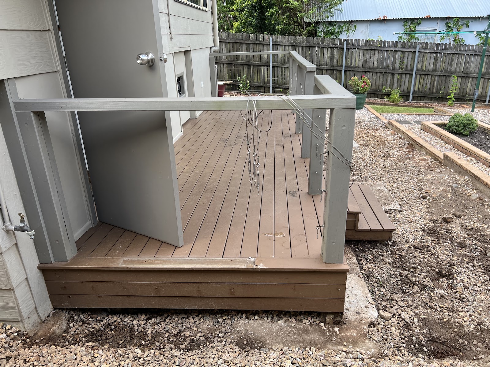 Composite deck with grey handrail posts under construction